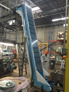 Trail mix feeding up a steep incline on a DynaClean food conveyor