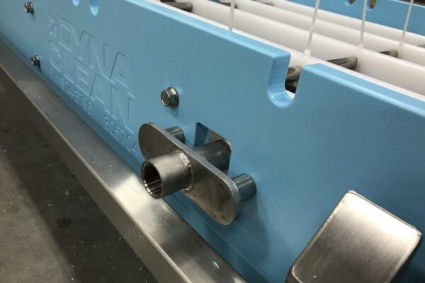 A close-up of a DynaClean washdown conveyor with a clean in place attachment