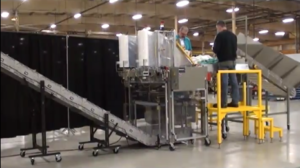 A DynaCon conveyor being used for automatically bagging commercial laundry