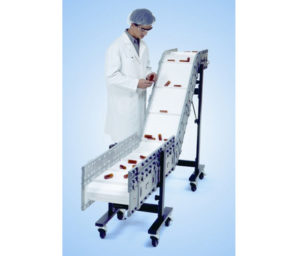 a man inspecting medical devices on a clean room conveyor