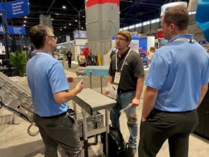 Discussing how Dynacon can provide custom conveyor solutions to a manufacturer at pack expo 2022