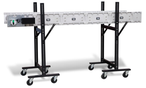 A portable DynaCon flat conveyor with adjustable height legs on rolling casters