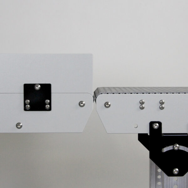 A DynaPro low profile conveyor end to end with another DynaPro conveyor with sidewalls