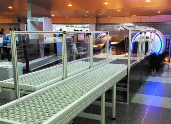 A DynaRoller zone powered conveyor in an airport security checkpoint area