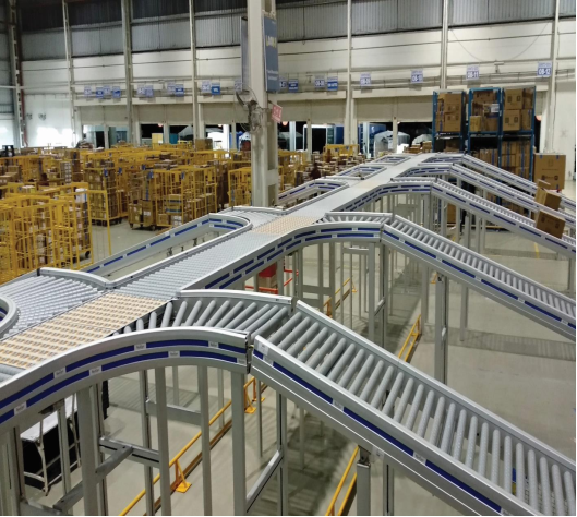 A system of ten incline roller conveyors conveying boxes up to a long zone powered conveyor in a distribution center