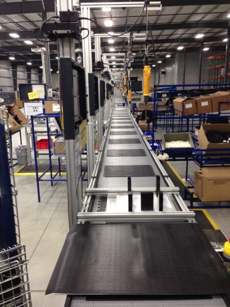 A hybrid trunk line conveyor in a packaging facility