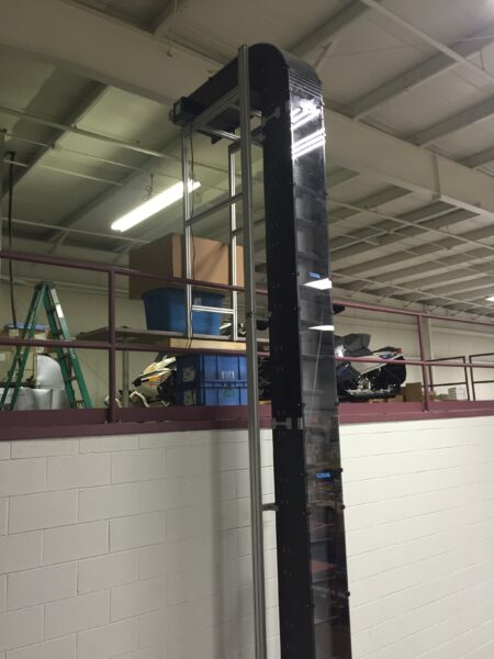 A Hybrid vertical bucket conveyor that climbs from a first floor to a second floor