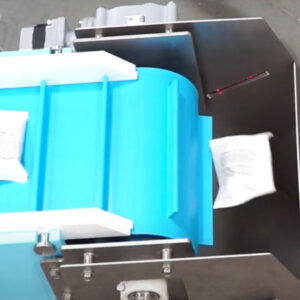 An overhead view of a DynaClean conveyor dropping food packages in white bags into an exit chute