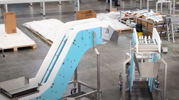 Two DynaClean conveyors that have just been assembled in a warehouse