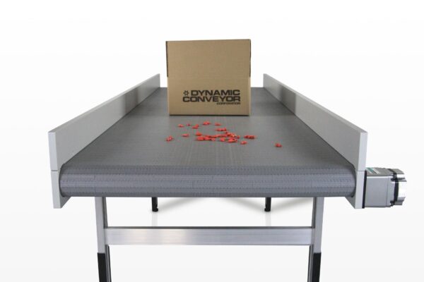 A DynaPro low profile conveyor with sidewalls, with a box and plastic parts on top