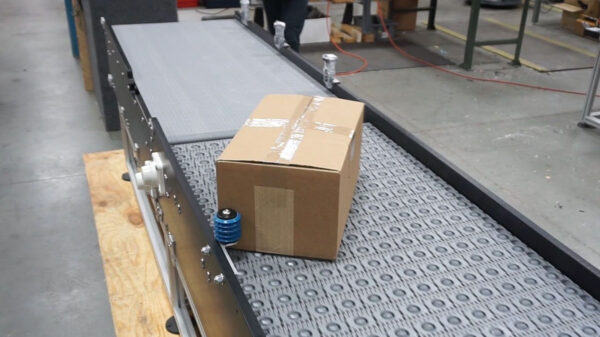 Dynamic Conveyor Case Turning Hybrid (1) A box on a case turning conveyor