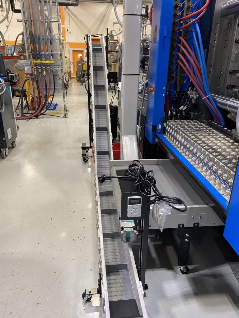 A DynaPro low profile, takeout conveyor in a manufacturing facility