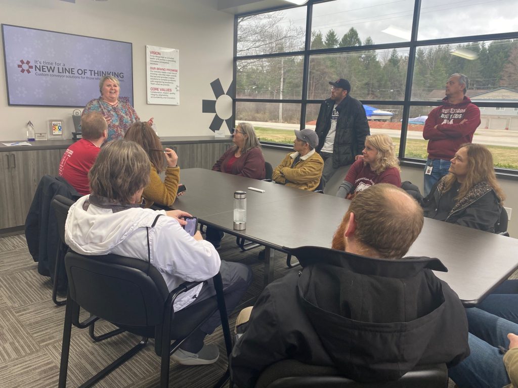Educators sit at the conference room table at Dynamic Conveyor Corporation as HR welcomes them to learn about workforce requirements in the manufacturing industry