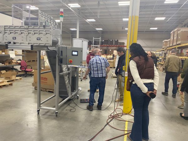 Production Supervisor Roy Garn shows area teachers a DynaCon conveyor system, showing them areas that require technical expertise, a characteristic desired in workforce candidates