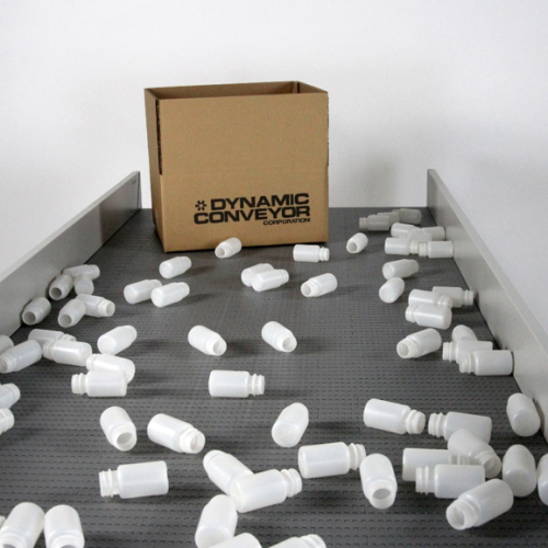 Close up of a DynaPro low profile conveyor conveying plastic medicine bottles