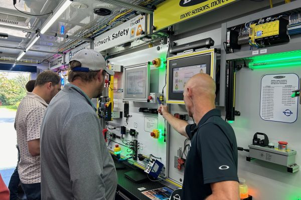 Engineering team looking at conveyor options like lighting