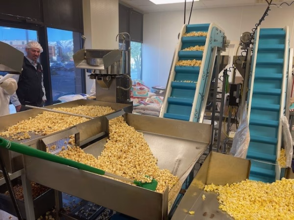 Popcorn Bulk fill 2 popcorn being filled into hopper from conveyor bucket section