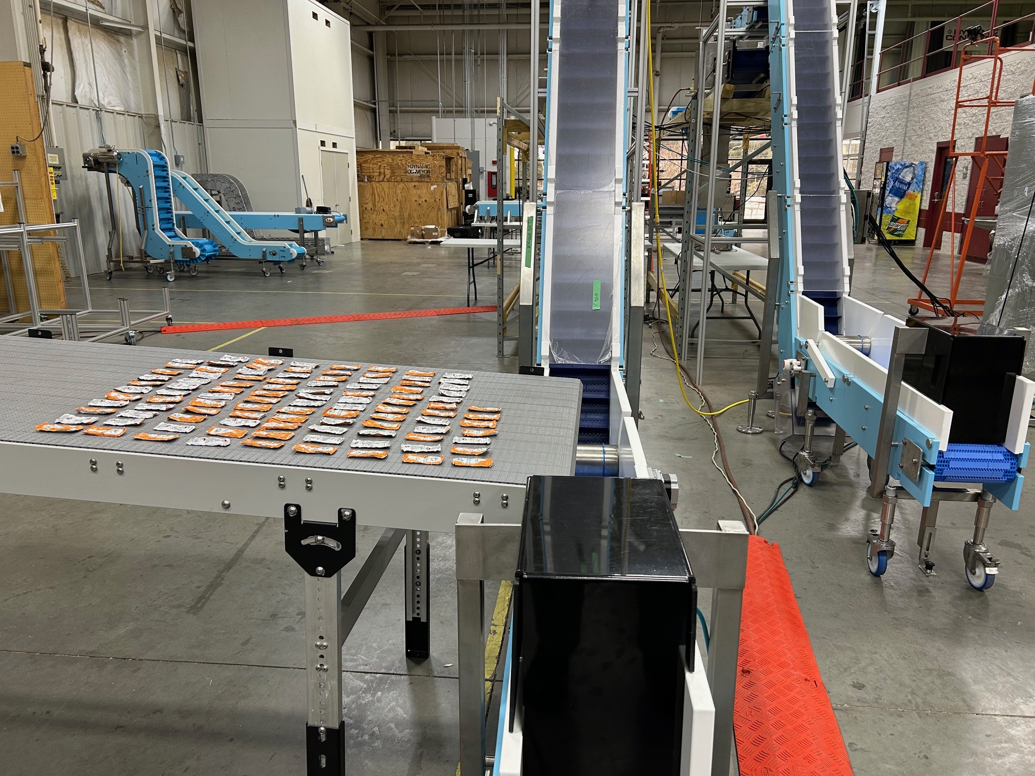 food packets on production line at end of conveyor
