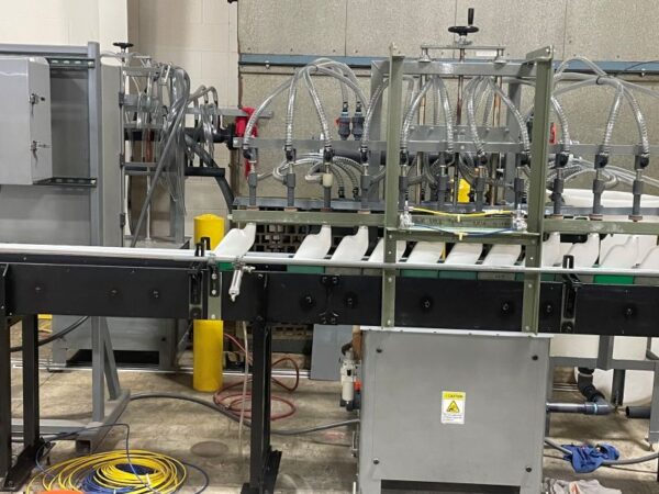 chemical-filling-operation caustic chemicals being filled in bottles on plastic DynaCon Conveyor