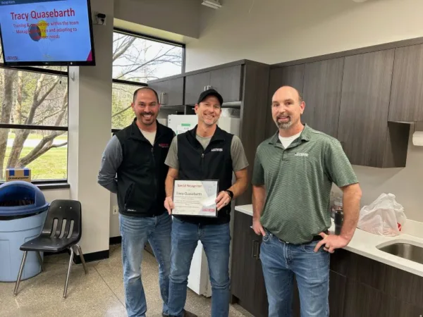 Tracy Quasebarth, Design Engineer receiving conveyor employee recognition award