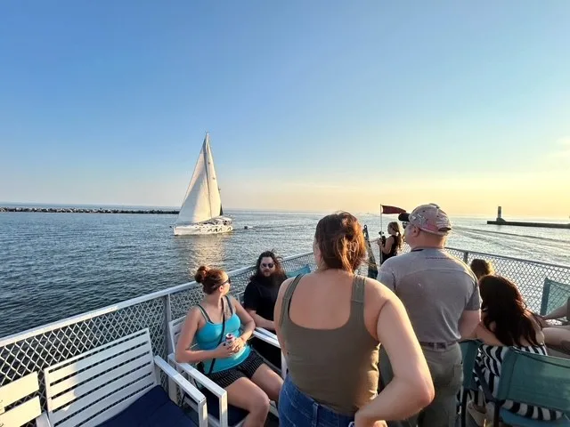 Sail boat off the side of the cruise boat
