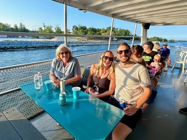 Scott, Jill and Allyson sitting at a table on the team cruise