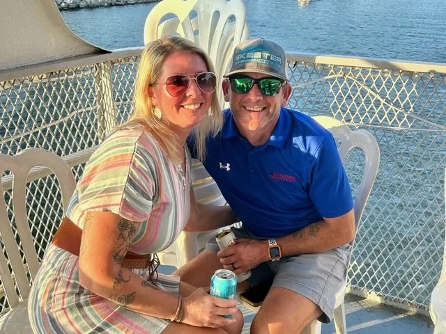 Spencer family smiling on the deck of the team cruise