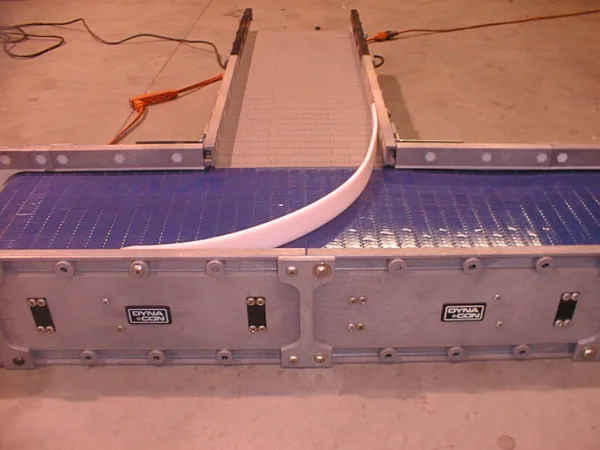 Transfer Conveyor 5 inline merge transfer system on a DynaClean conveyor belt