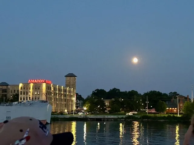 Moon in the sky at night over West Michigan cityscape