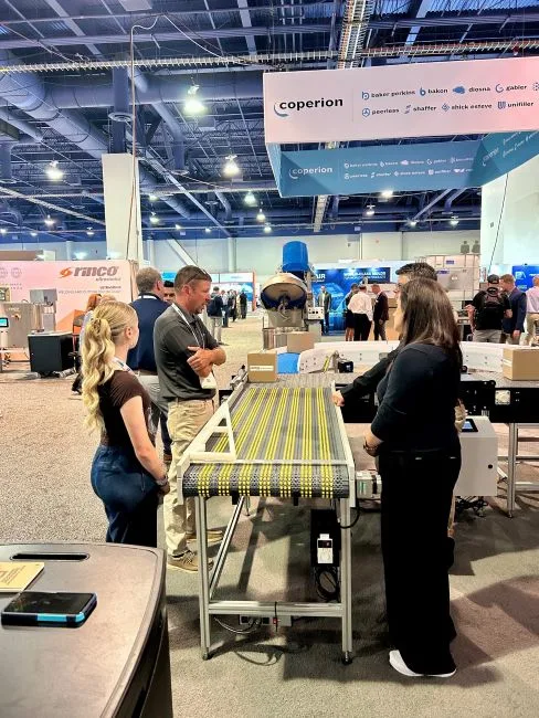 MIke and his daughter at thesmart conveyor display at Pack Expo 2025 Las Vegas