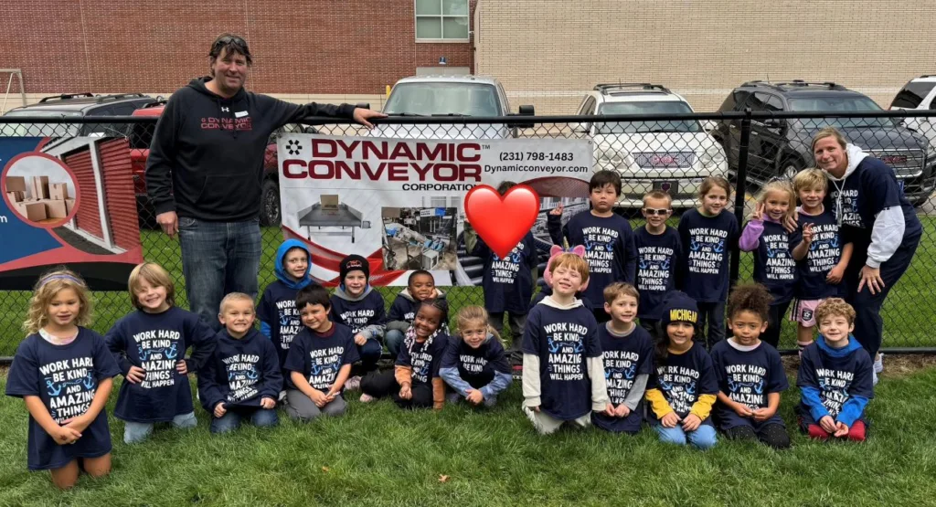 class poses in front of Dynamic Conveyor banner at Lincoln Park Elementary for walkathon
