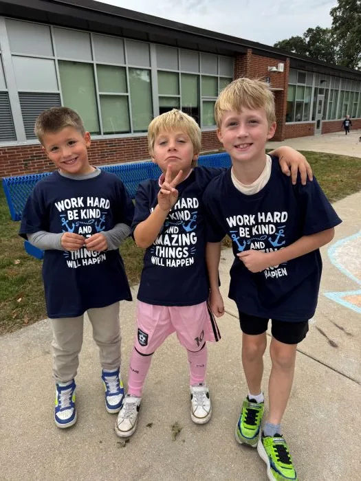 3 students with walkathon shirts at norton shores school