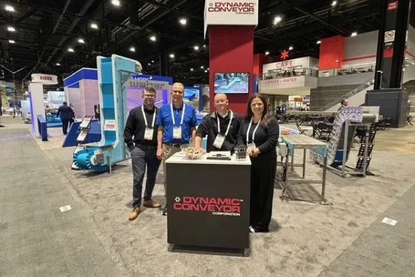 EATS-2025-booth-DC Tradeshow staff from Dynamic Conveyor standing in from of booth at EATS 2025