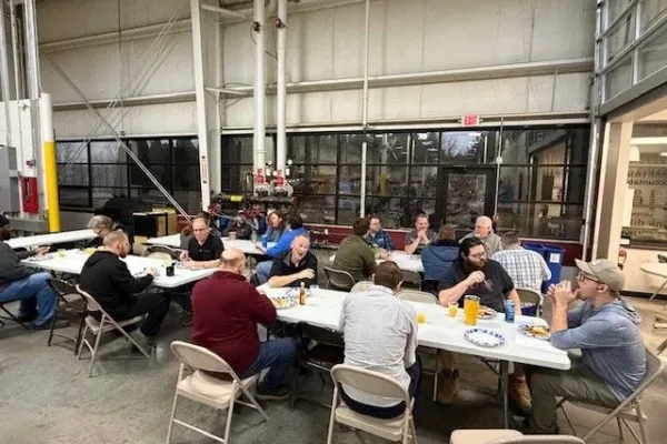 thanksgiving-2025-pancake-breakfast Dynamic Conveyor staff sitting at tables to enjoy their breakfast