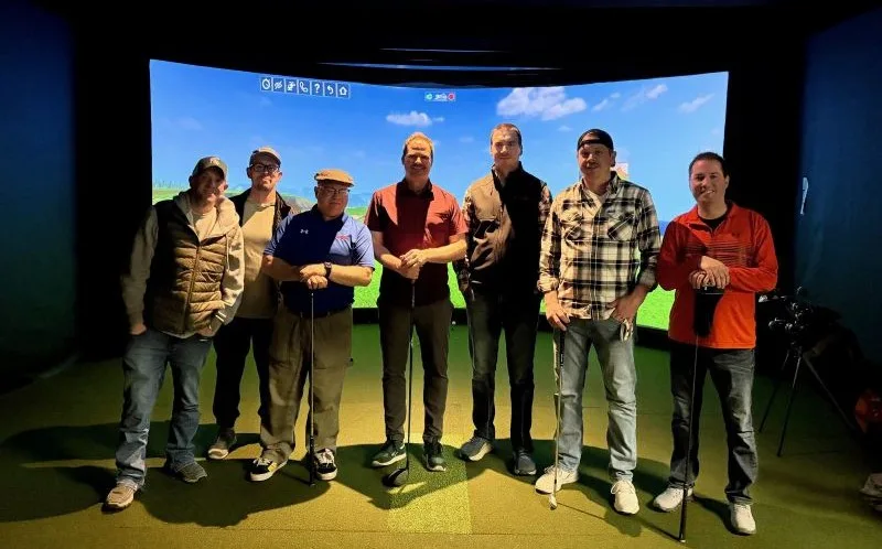 Team-DCC-Simulator-Golf team standing in front of golf simulator screen