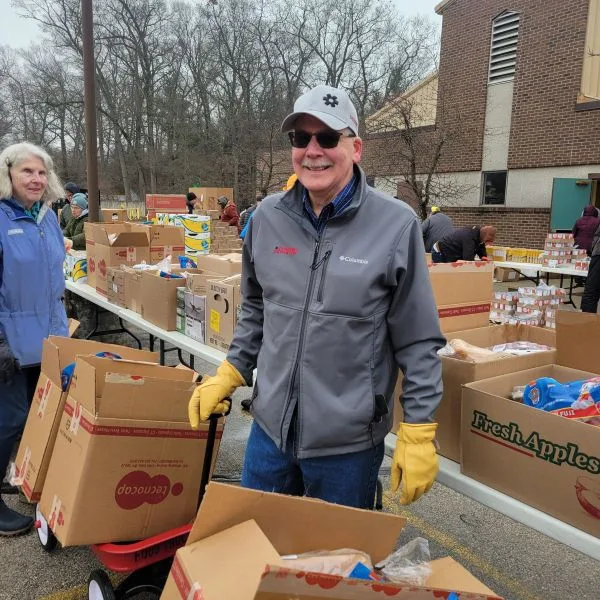 Tim-DeVriendt-Feeding-America Tim DeVriendt smiling as he works the Feeding America West MI event in 2026