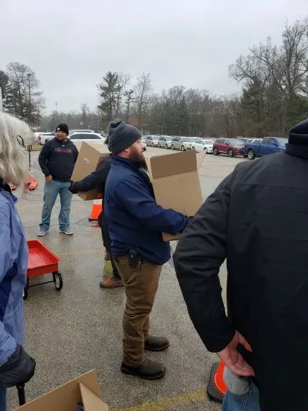 feeding-america-WM-workers-2 workers carrying boxes of food in parking lot