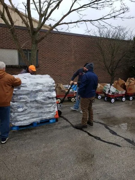 feeding-america-pallet-food volunteers moving pallet of food at charity event