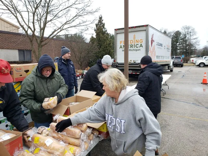 feeding-america-volunteers-2026-2 volunteers sorting and unpacking bread