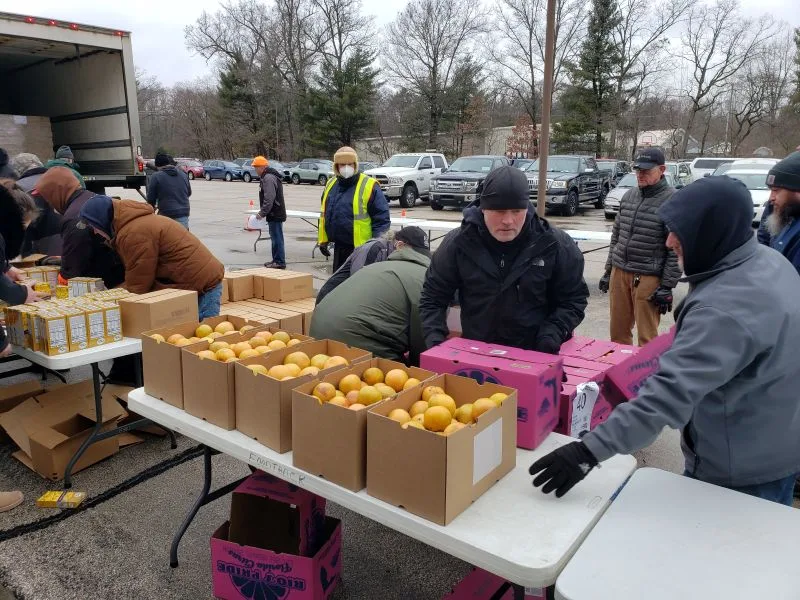 feeding-america-volunteers-2026-8 workers sorting oranges at charity event