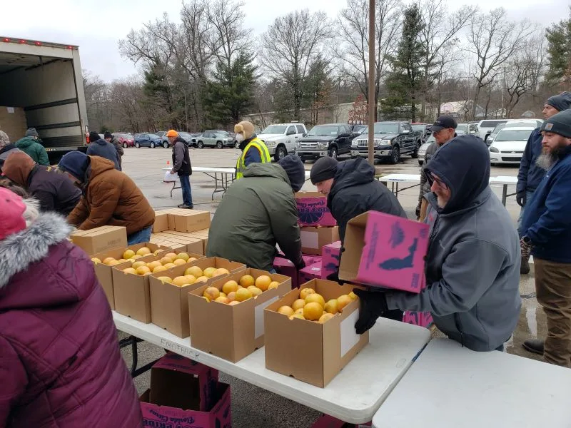 feeding-america-volunteers-2026-9 boxes of oranges for Feeding America
