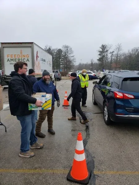 feeding-america-volunteers-2026 volunteers ready to load food into cars