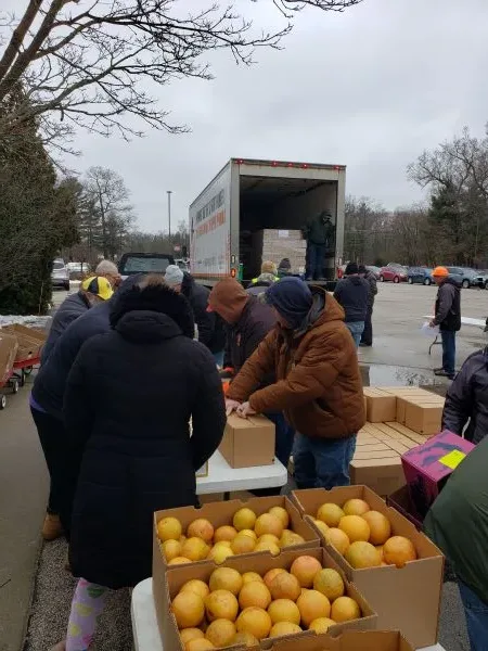 fruit-feeding-america workers unloading oranges and boxes of food