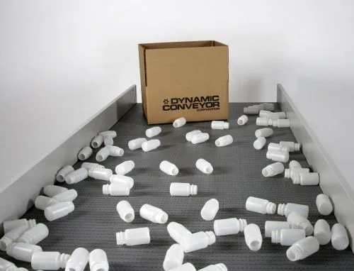 dynapro conveyor with plastic bottles and cardboard box on conveyor belt