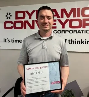 John Ehlich holding his 2026 Q1 employee recognition certificate