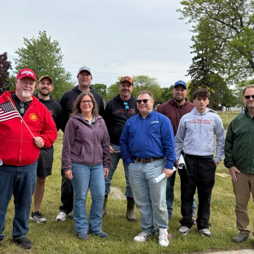 Dynamic Conveyor Team at Sunrise Memorial Gardens to place flags on veterans gravesites for memorial day