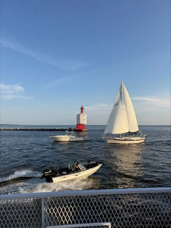 Boats-lighthouse-2026 view from ship with lighthouse and sailboat on the water