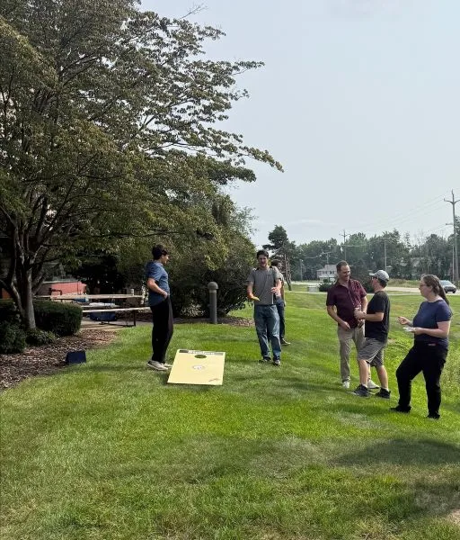 july-2026-celebration-cornhole Dynamic Conveyor staff playing cornhole to celebrate sales success