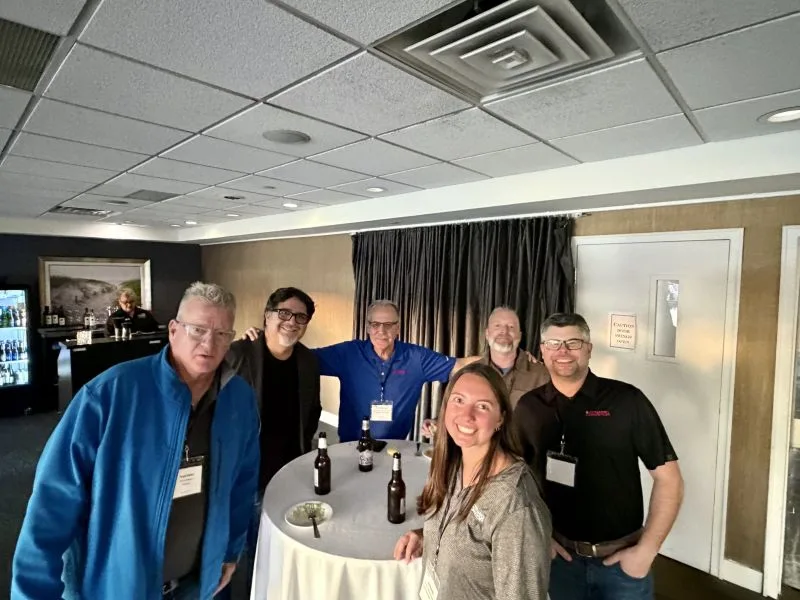 Lexi-Chris-Tim-Reps-2026-summit Group of dynamic conveyor staff and partners at the lake house for Partner Summit 2026